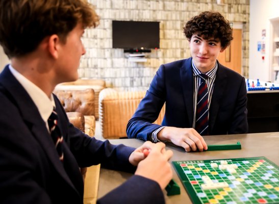 Boarders having fun playing Scrabble together in the Abraham Common Room