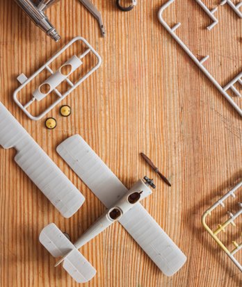 Parts of a model aircraft laid out on a table ready to be assembled