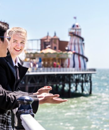 Pupils on a sunny day enjoying chatting on the Pier looking out at the view of the sea