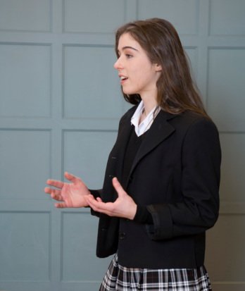 Pupil in a Presentation Skills lesson giving a speech to the rest of the class