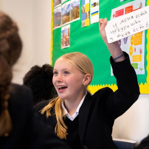  Pupil practicing their writing on a whiteboard in a Russian lesson 