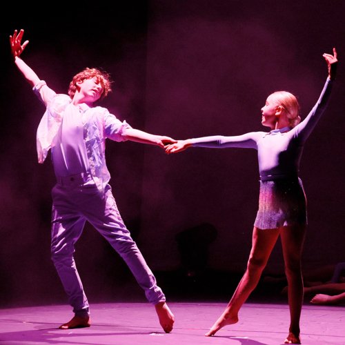  Dance pupils holding hands during their duet performance together on stage in the Dance Show 