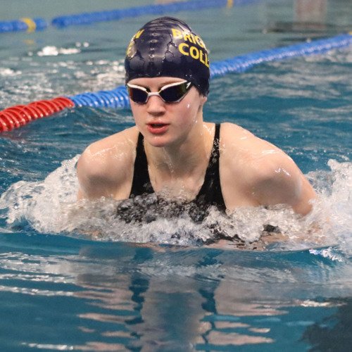  Astrid competing in a Brighton College Swimming hat competing in a gala in the Lido swimming pool 