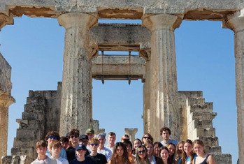 Pupils standing in front of the Acropolis on a Classics Trip to Athens