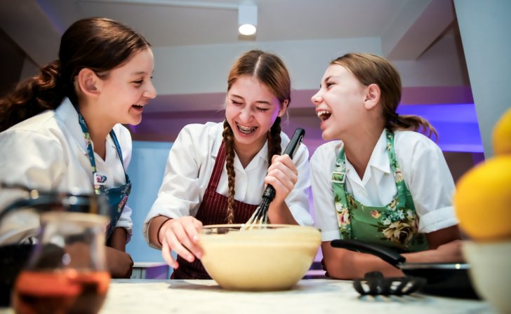  Boarding pupils enjoying baking together in the kitchen 