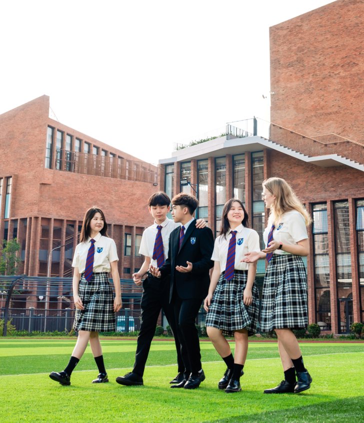  Pupils walking along the grass in front of Brighton College Vietnam 