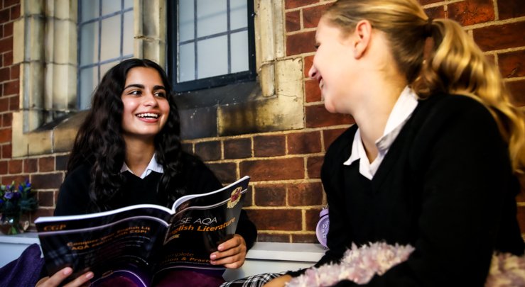  Pupils sitting in the New House study area and revising from an English Literature study guide together 