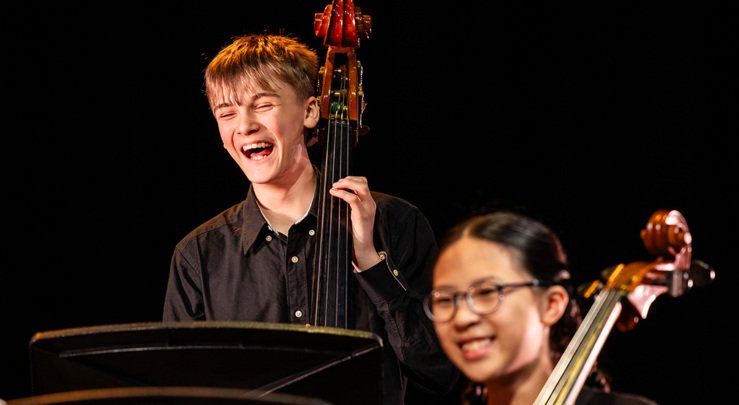  Music pupils enjoying performing a piece on the cello and double bass 