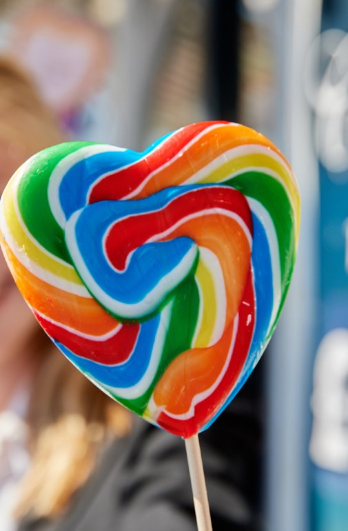  Smiling pupil holding a rainbow heart lollipop on the Pier 